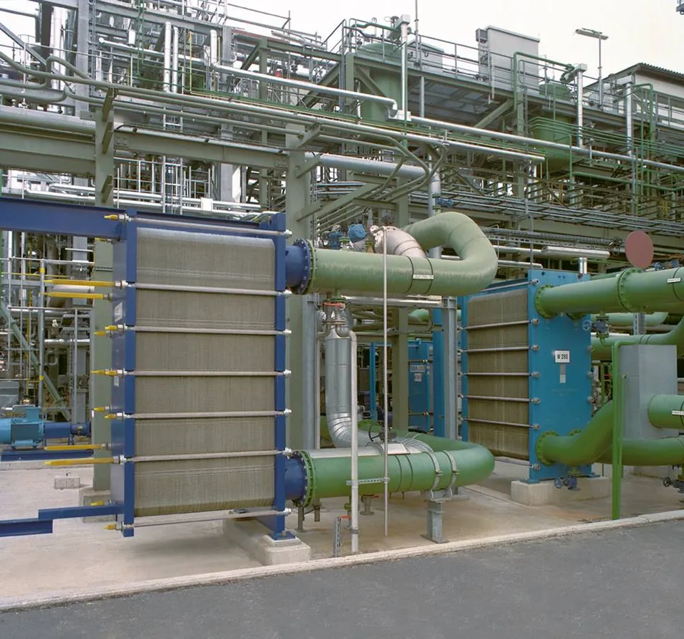 Plate heat exchangers connected to green pipework in an industrial plant